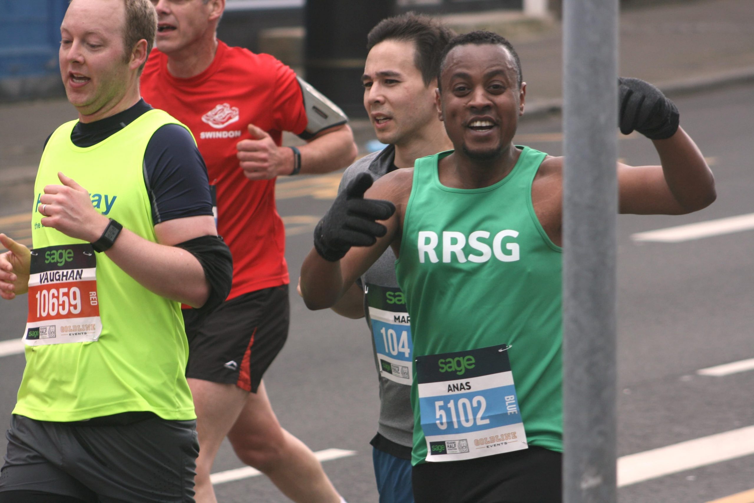 Smiling runner in Reading Refugee Support Group vest