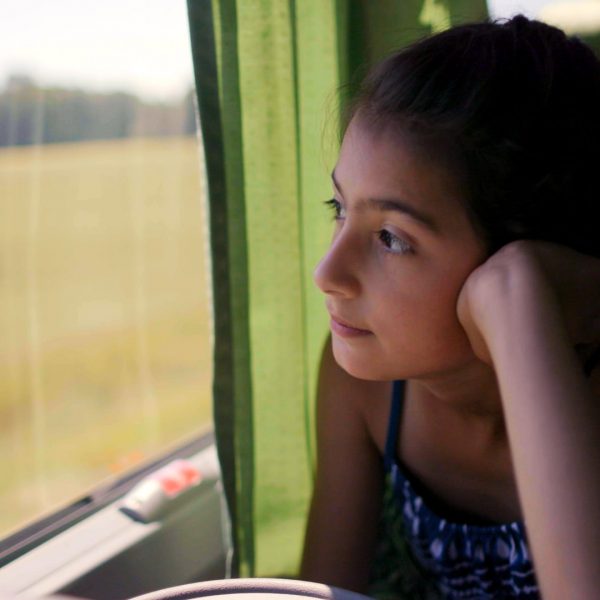 Girl looking out of a train window