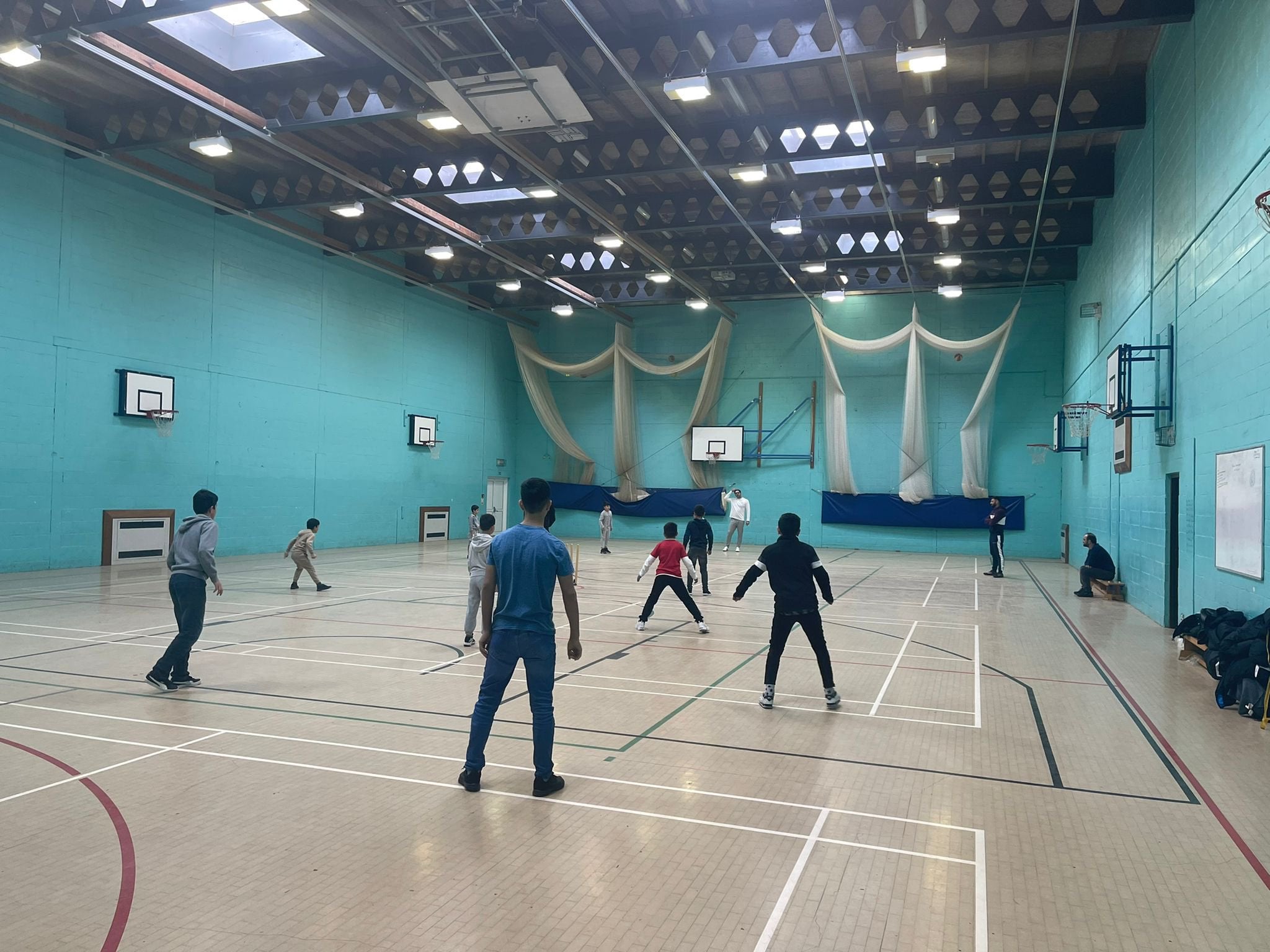 Refugees having a cricket lesson